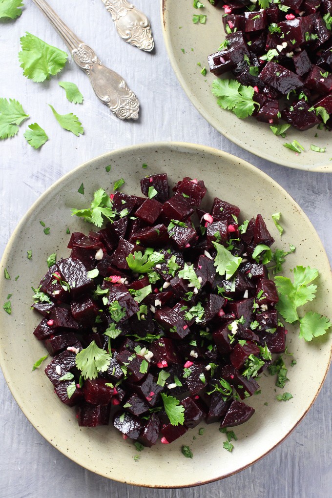 Top view of the Mediterranean Beets with Garlic and Olive Oil on a plate standing on grew background.